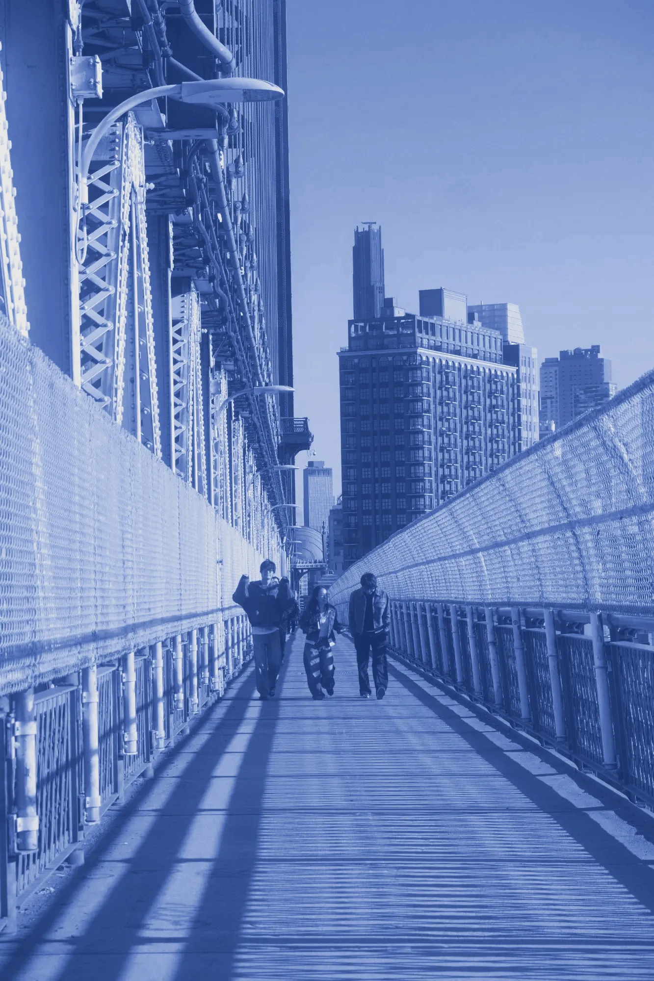 Friends walking across a bridge walkway toward the city skyline, printed in cyanotype blue.