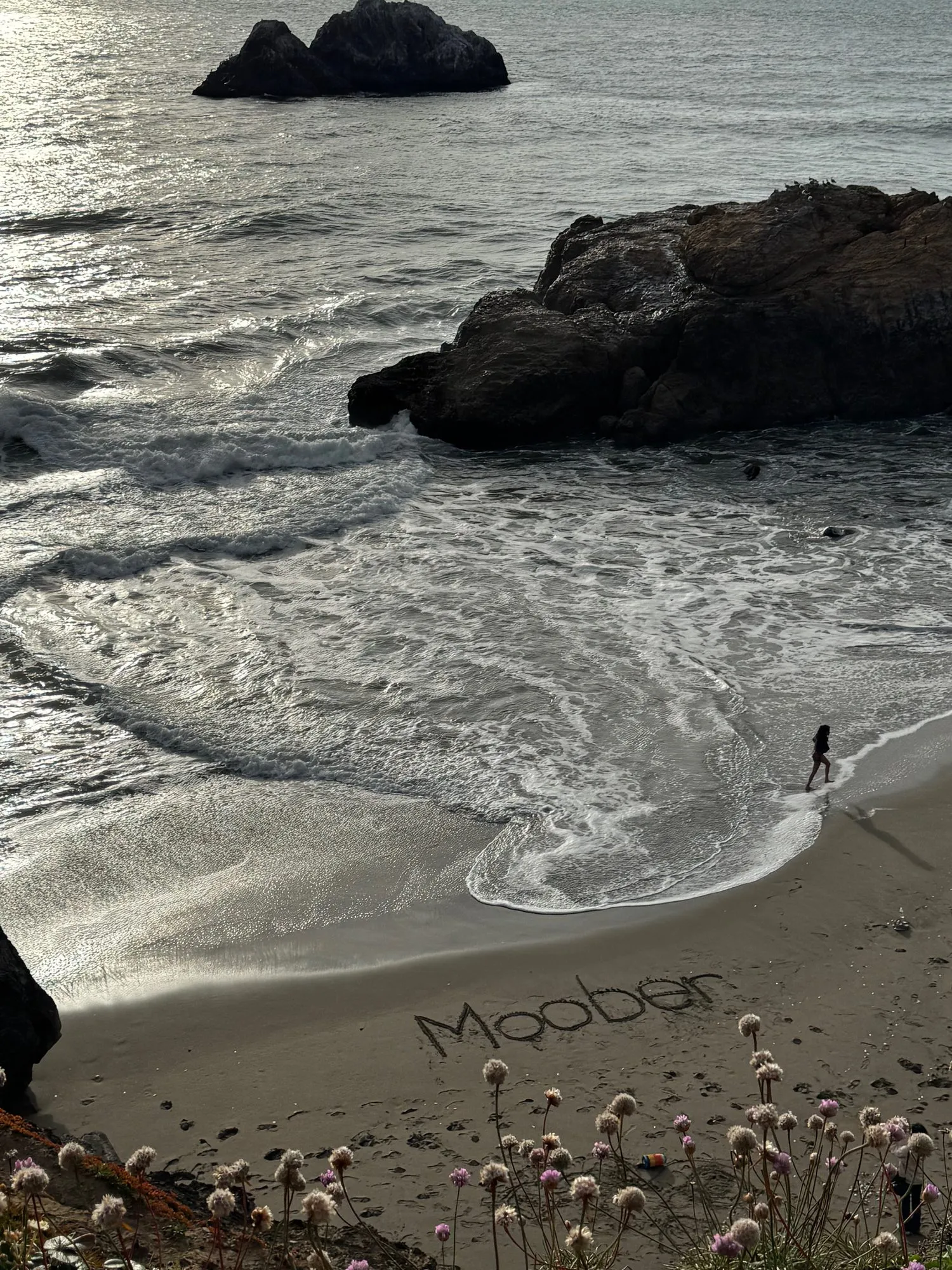 A team trip to San Francisco: Moober written in the sand on a beach.